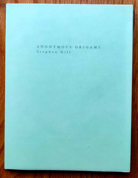 The photography book cover of Anonymous Origami by Stephen Gill. In paperback bright light blue. signed.