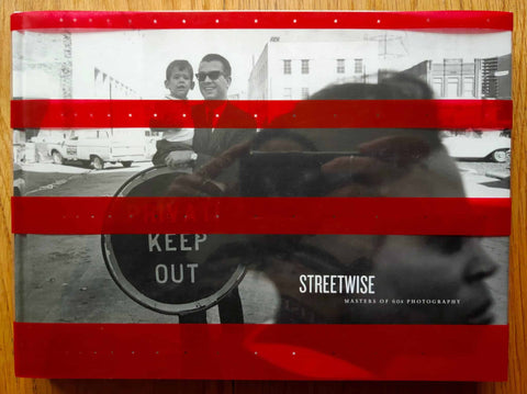 The photography book cover of Streetwise - Masters of 60s photography by Andy Grundberg. Hardback in b&w with red strips across the cover with stars in them.