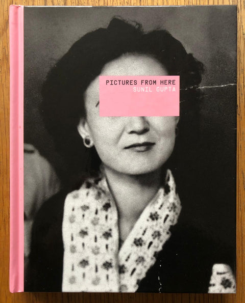 The photography book cover of Pictures from Here by Sunil Gupta. Hardback in B&W with pink border. Signed.