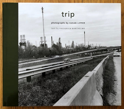 The photography book cover of Trip by Susan Lipper. Hardback green spine and B&W image of a road.