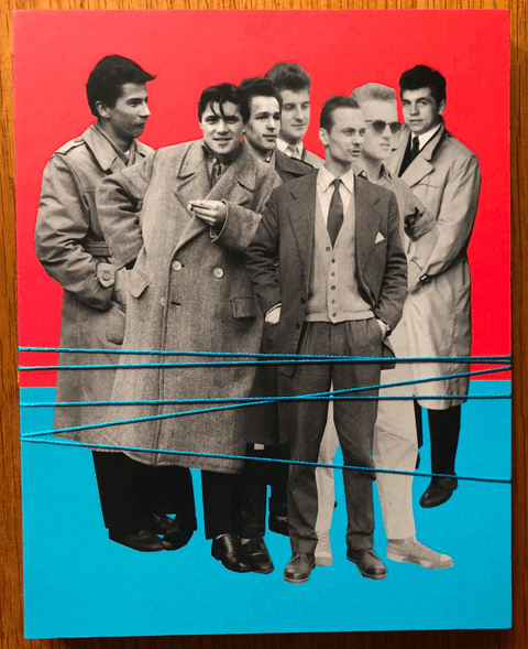 The photography book cover of The First March of Gentlemen by Rafal Milach. Hardback blue and red cover.