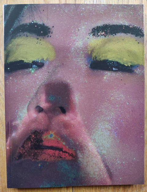 The photography book cover of All I want to be by Thomas de Kluyver. Paperback with image of a glittery face with yellow eyeshadow.