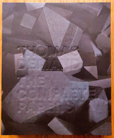 The photography book cover of The Complete Papers by Thomas Demand. Hardback with 3D geometric shapes on the cover.