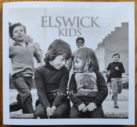 The photography book cover of Elswick Kids by Tish Murtha. Paperback with image of two kids looking at one another.