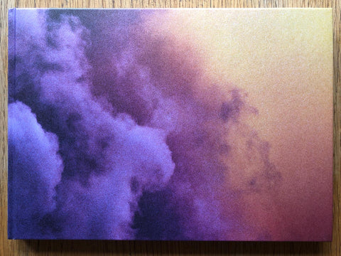 The photography book cover of Crimson Line by Trent Parke. Hardback with purple clouds against an orange sky.
