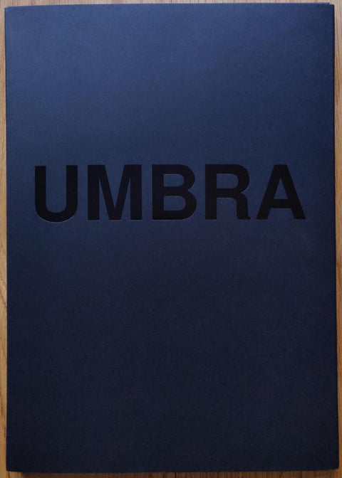 The photobook cover of Umbra by Viviane Sassen. In softcover dark blue. Signed.