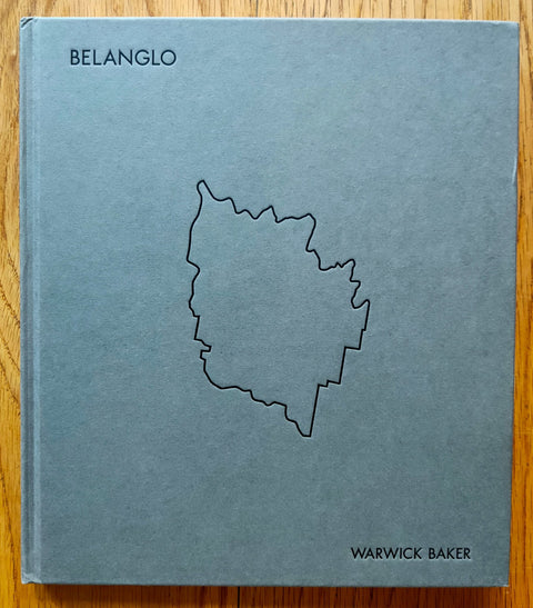 The photography book cover of Belanglo by Warwick Baker. Hardback in grey with outline of Belanglo state.