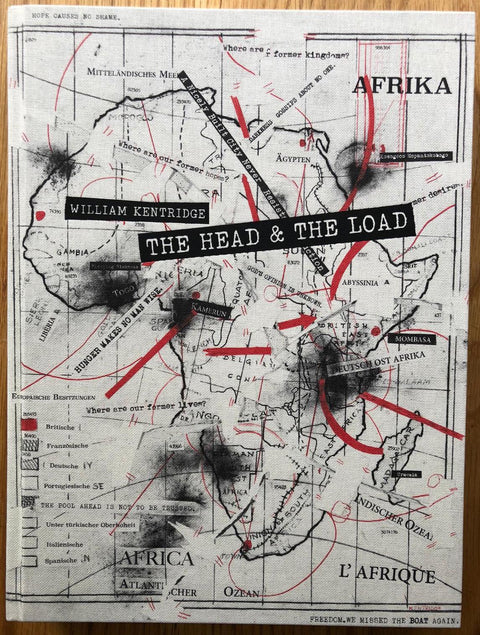 The photography book cover of The Head & the Load by William Kentridge. Hardback in white with map of africa in black and red.