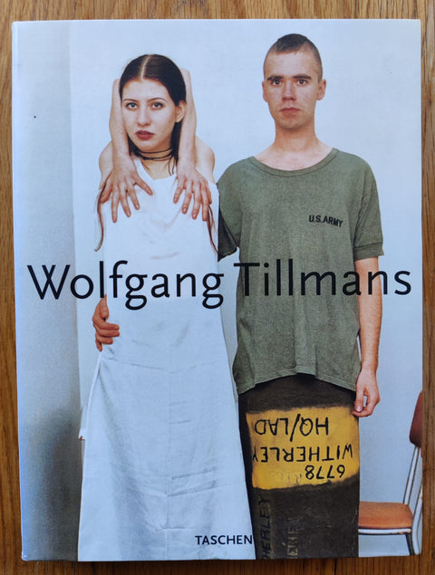 The photography book cover of Wolfgang Tillmans by Wolfgang Tillmans. Hardback with image of a boy and girl on the cover, the girl has her hands contorted around her body.
