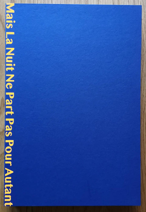 The photography book cover of Mais La Nuit Ne Part Pas Pour Autant by Xiaoliang Huang. Paperback in slipcase cover in bright cobalt blue with yellow title. Signed.