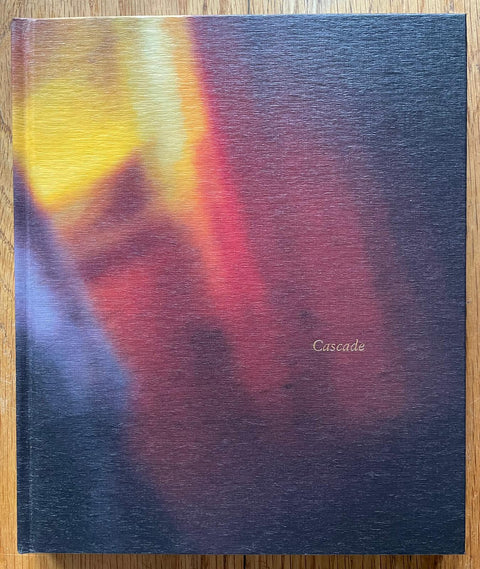 The photography book cover of Cascade by Yasuhiro Ogawa. Hardback with red, yellow and black on the cover. Signed.