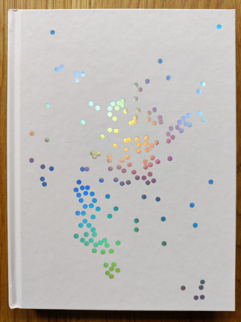 The photography book cover of The Good Side by Yoshiyuki Okuyama. Hardback in white with colourful sparkles on the cover. Signed.