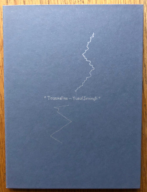 The photography book cover of Tourmaline by Yusuf Sevincli. Hardback in blue. Signed.