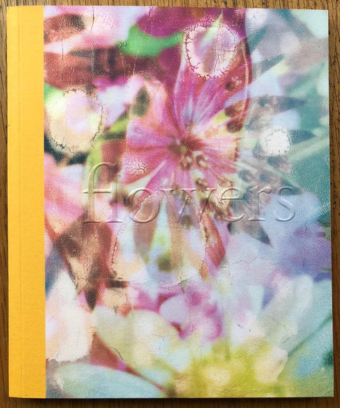 The photography book cover of Flowers by Zara Carpenter. Paperback with yellow binding and flowers on the cover. Signed.